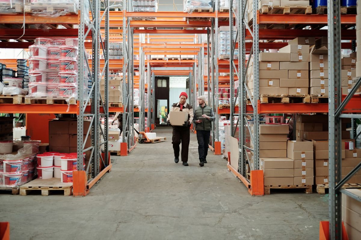 A wholesale apparel warehouse aisle with packed goods on tall racks