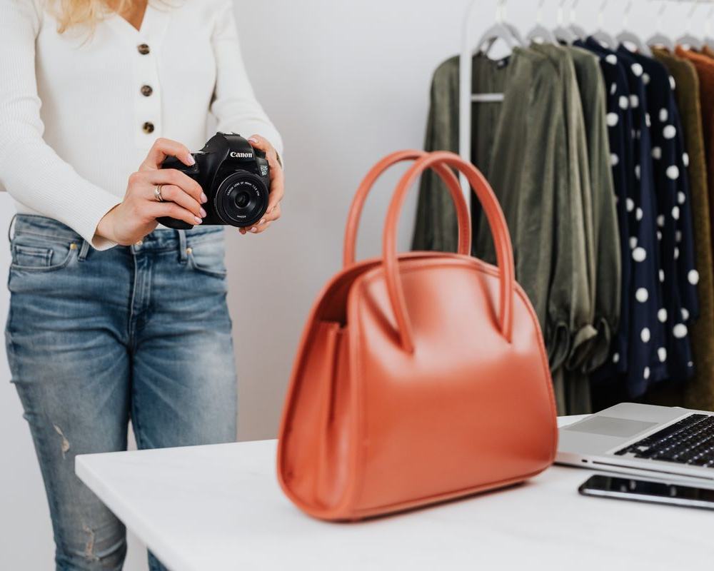 Reseller photographing a handbag to list it online