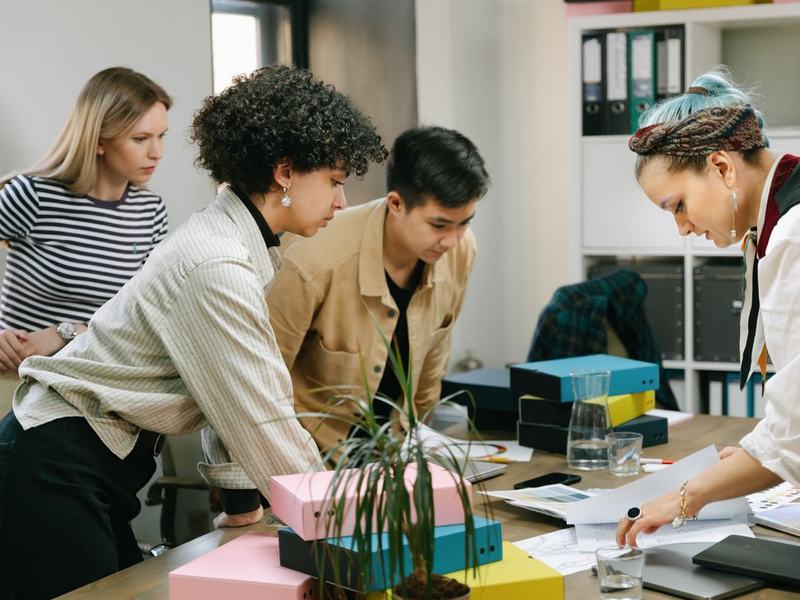 Brand team reviewing product sheets